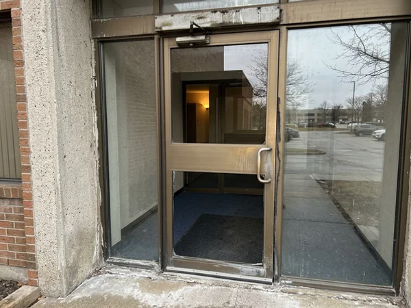 Before: dated single lobby door at a Mississauga office